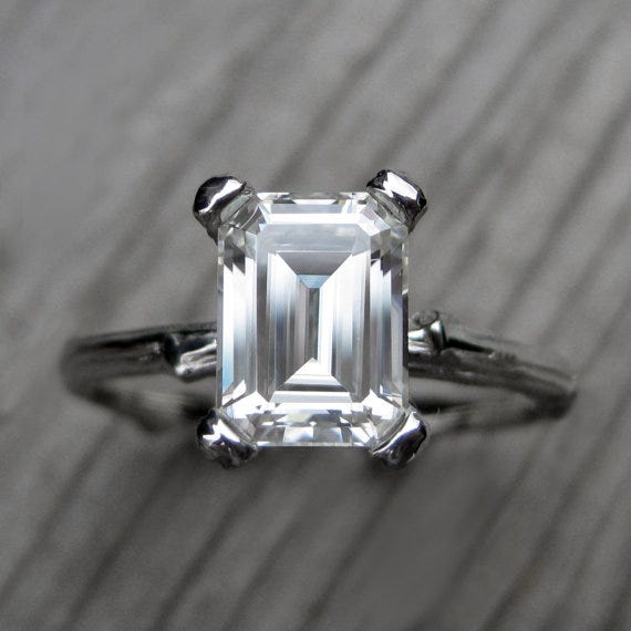 An emerald cut engagement ring by Kristin Coffin 