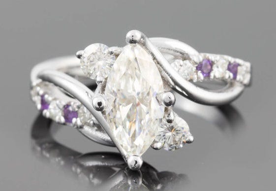 Amethyst was considered a precious gem until the mid-1800s. Marquise Engagement Ring, Moissanite & Amethyst, Laurie Sarah Designs, $2,022