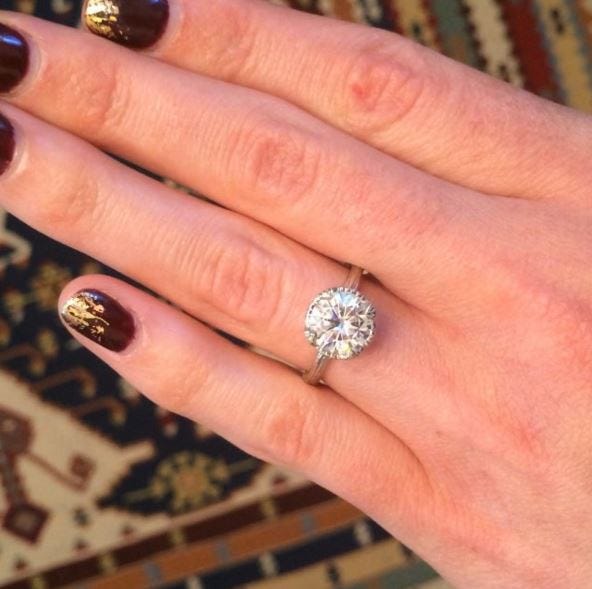 Kristin Coffin’s sparkly metallic mani looks great with this Forever One™ moissanite engagement ring! 