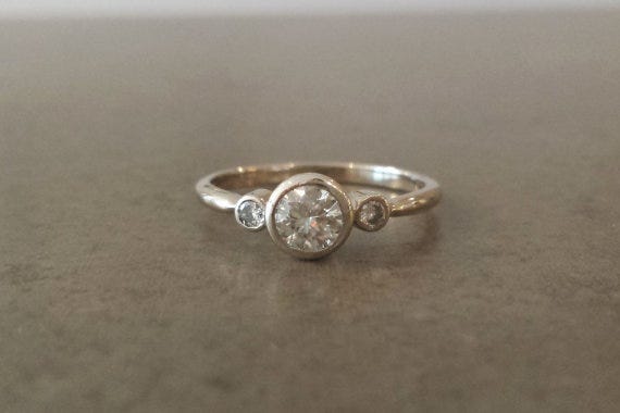 A three stone ring featuring traditional graduation. Alchemy House, $1,004.55
